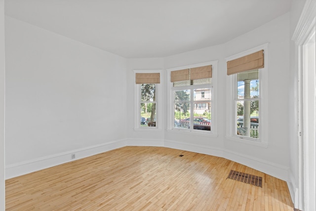 spare room with hardwood / wood-style flooring