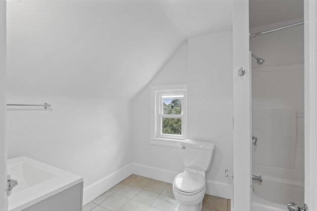 full bathroom featuring toilet, vanity, vaulted ceiling, and tile patterned flooring