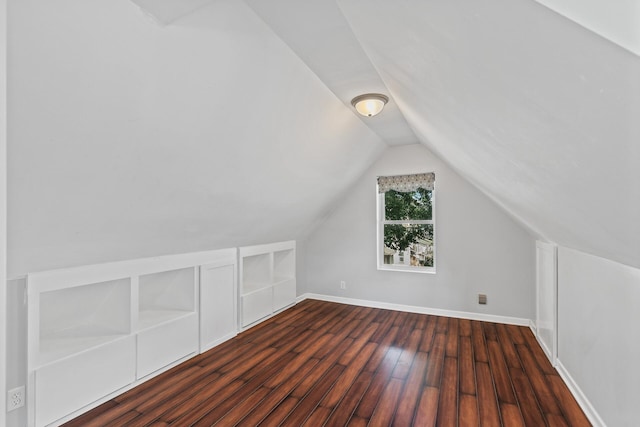 bonus room featuring dark wood-type flooring and lofted ceiling