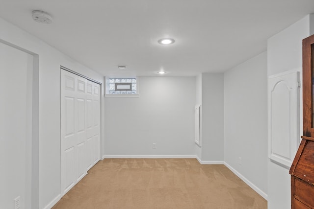 basement featuring light colored carpet