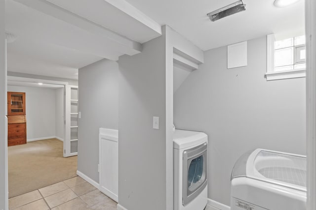 bathroom featuring separate washer and dryer and tile patterned floors