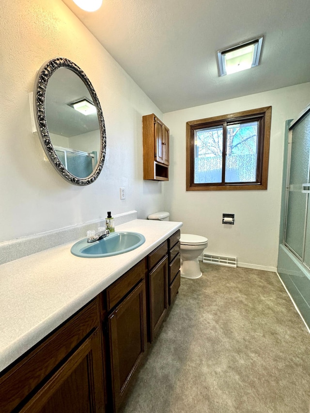 full bathroom featuring bath / shower combo with glass door, vanity, and toilet