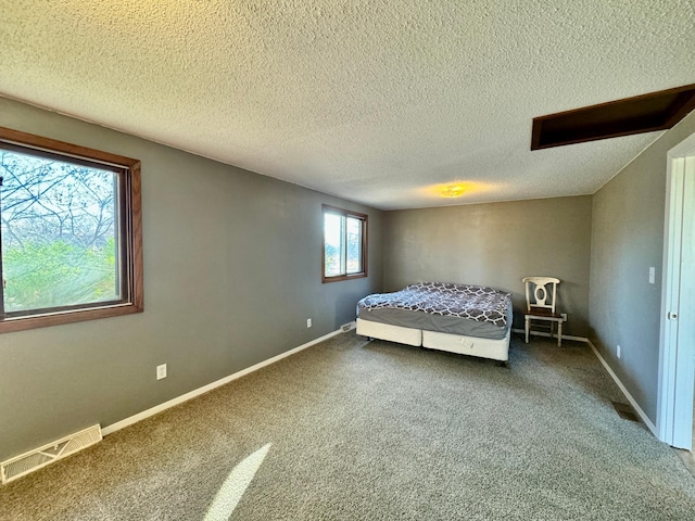 unfurnished bedroom featuring a textured ceiling and carpet