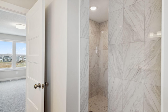 bathroom with tiled shower