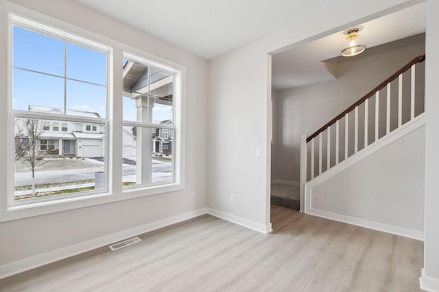 spare room featuring light wood-type flooring