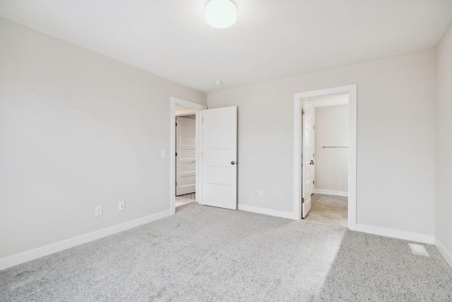 unfurnished bedroom with light colored carpet