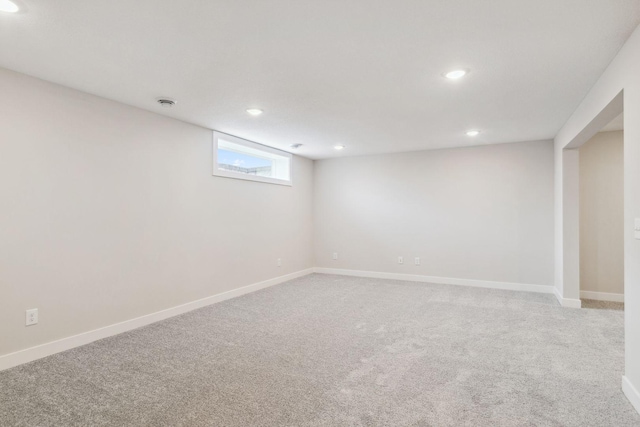 basement featuring light carpet