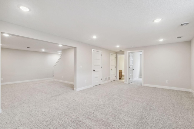 basement featuring light colored carpet