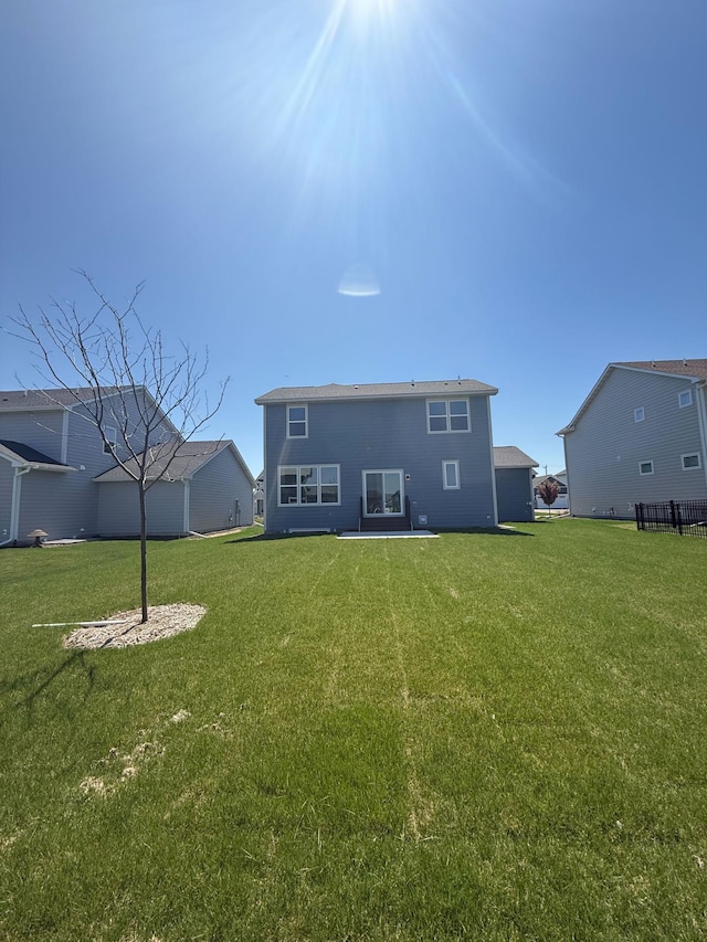 back of house featuring a yard