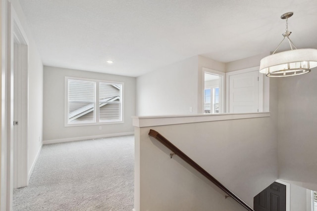 10191 Arrowwood Path, Woodbury, MN 55129 - hallway with carpet, baseboards, an upstairs landing, recessed lighting, and a chandelier