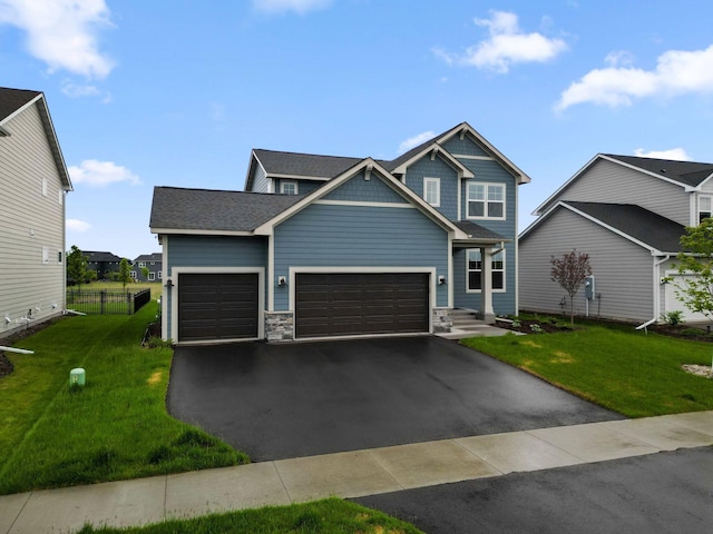10191 Arrowwood Path, Woodbury, MN 55129 - craftsman house featuring an attached garage, driveway, and stone siding