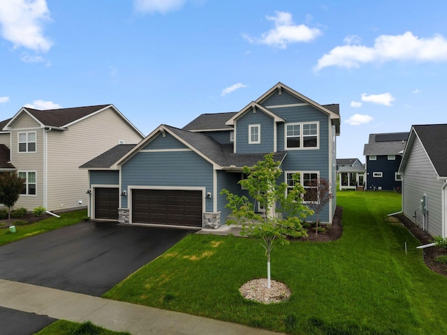 10191 Arrowwood Path, Woodbury, MN 55129 - view of front of home featuring an attached garage, asphalt driveway, a front lawn, and roof with shingles