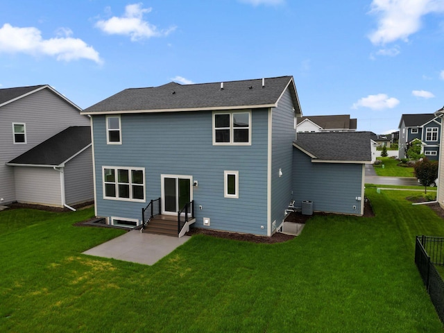 10191 Arrowwood Path, Woodbury, MN 55129 - back of house with a patio, a yard, central AC, and roof with shingles