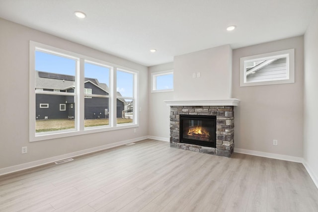 10191 Arrowwood Path, Woodbury, MN 55129 - unfurnished living room featuring wood finished floors, a fireplace, and recessed lighting