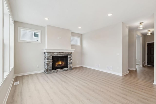 10191 Arrowwood Path, Woodbury, MN 55129 - unfurnished living room with light wood-type flooring, a fireplace, and recessed lighting