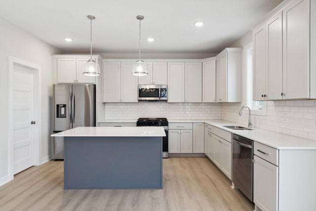 10191 Arrowwood Path, Woodbury, MN 55129 - kitchen featuring appliances with stainless steel finishes, light wood-style flooring, decorative backsplash, a kitchen island, and light countertops