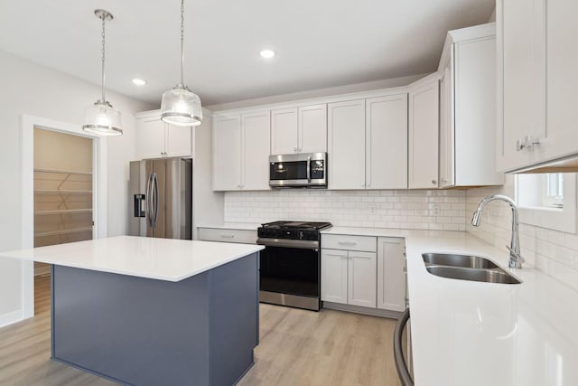 10191 Arrowwood Path, Woodbury, MN 55129 - kitchen featuring appliances with stainless steel finishes, light wood-type flooring, tasteful backsplash, a kitchen island, and recessed lighting
