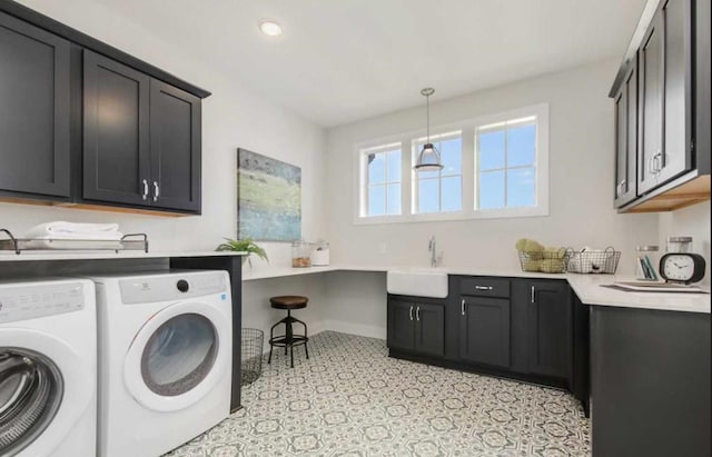 washroom featuring cabinets, sink, and washer and clothes dryer