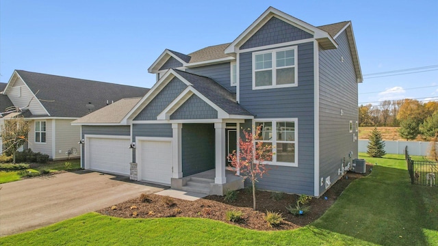 view of front of house featuring central AC, a front lawn, and a garage