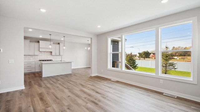 unfurnished living room with light wood-type flooring