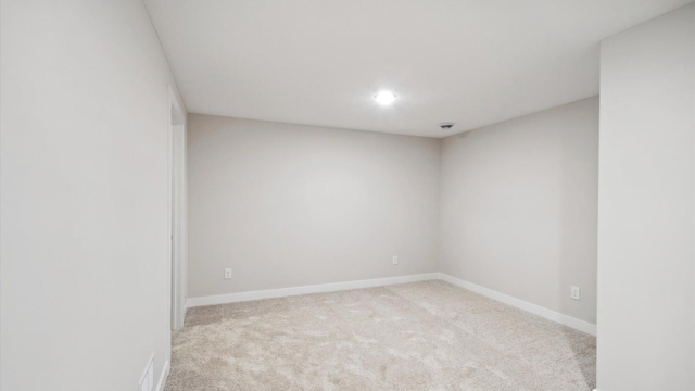 unfurnished room with light carpet