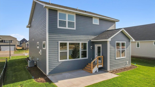 rear view of house featuring a patio, central AC, and a lawn