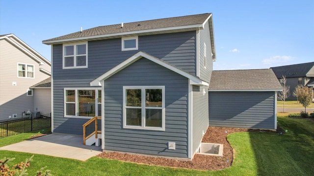 back of property featuring a patio, a lawn, and central AC