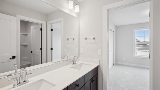 10238 Arrowwood Path, Woodbury, MN 55129 - bathroom featuring baseboards, double vanity, and a closet