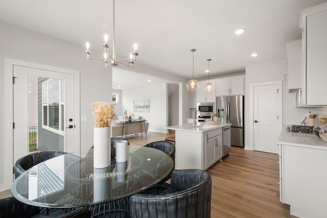 10238 Arrowwood Path, Woodbury, MN 55129 - dining space with light wood-style floors, recessed lighting, and a chandelier