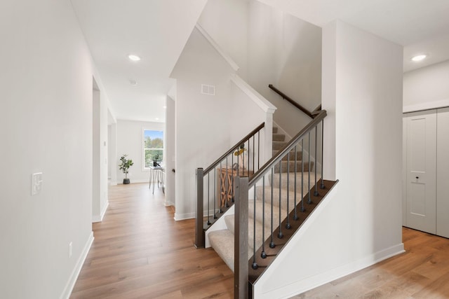 10238 Arrowwood Path, Woodbury, MN 55129 - stairway featuring wood finished floors, recessed lighting, and baseboards