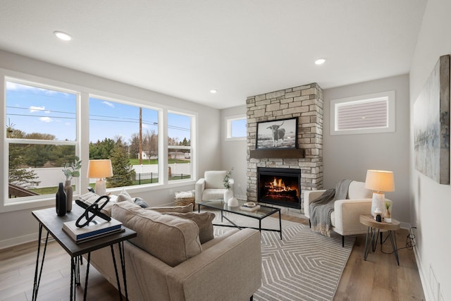 10238 Arrowwood Path, Woodbury, MN 55129 - living area featuring a fireplace, wood finished floors, baseboards, and recessed lighting