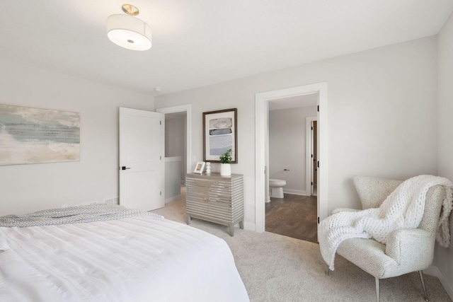 10238 Arrowwood Path, Woodbury, MN 55129 - bedroom featuring light carpet, ensuite bath, and baseboards