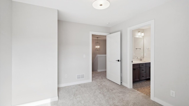 10238 Arrowwood Path, Woodbury, MN 55129 - unfurnished bedroom with carpet floors, connected bathroom, baseboards, and a chandelier