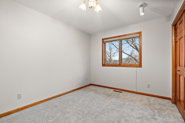 unfurnished bedroom featuring carpet and a textured ceiling