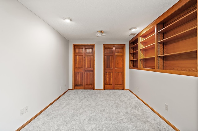 unfurnished bedroom with carpet floors and a textured ceiling