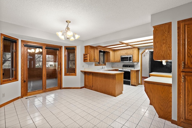 kitchen with kitchen peninsula, refrigerator, a textured ceiling, white electric stove, and a chandelier