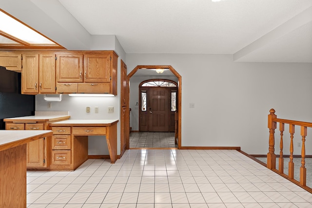 kitchen with black refrigerator and light tile patterned floors