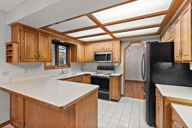 kitchen featuring sink, kitchen peninsula, stainless steel appliances, and light tile patterned floors