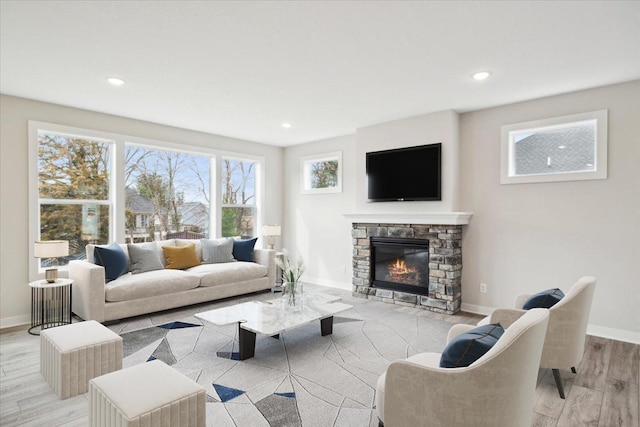 living room with light wood-type flooring and a fireplace