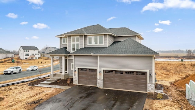 11728 35th St N, Lake Elmo, MN 55042 - view of front of property featuring asphalt driveway, a shingled roof, and stone siding