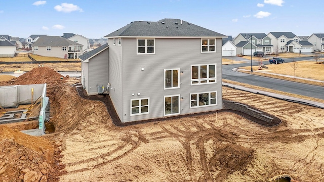 11728 35th St N, Lake Elmo, MN 55042 - back of house with a residential view and a shingled roof