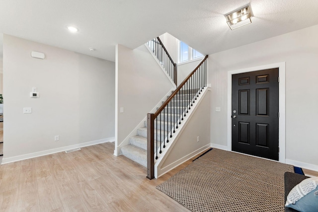 11728 35th St N, Lake Elmo, MN 55042 - entrance foyer with light wood-style flooring, stairway, and baseboards