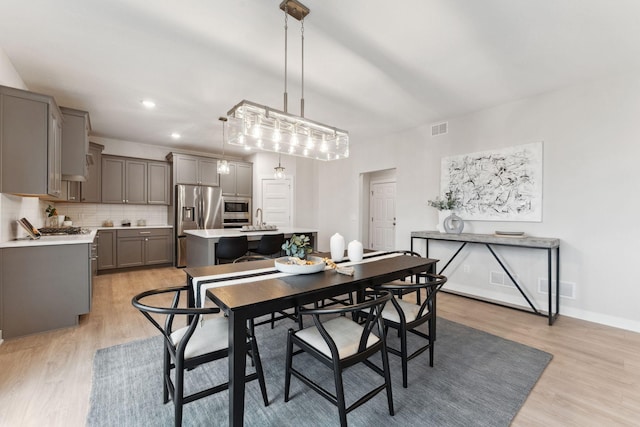 11728 35th St N, Lake Elmo, MN 55042 - dining room featuring light wood-style floors, recessed lighting, and baseboards