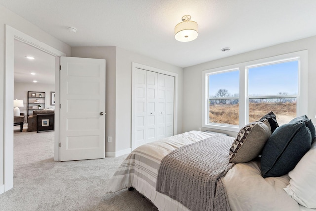 11728 35th St N, Lake Elmo, MN 55042 - bedroom with light carpet, a closet, and baseboards