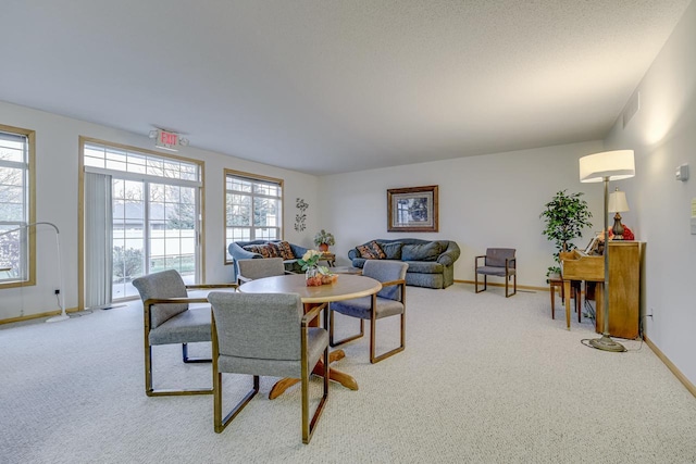 dining room with light colored carpet