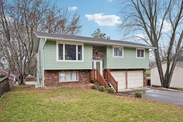 split foyer home with a garage and a front yard