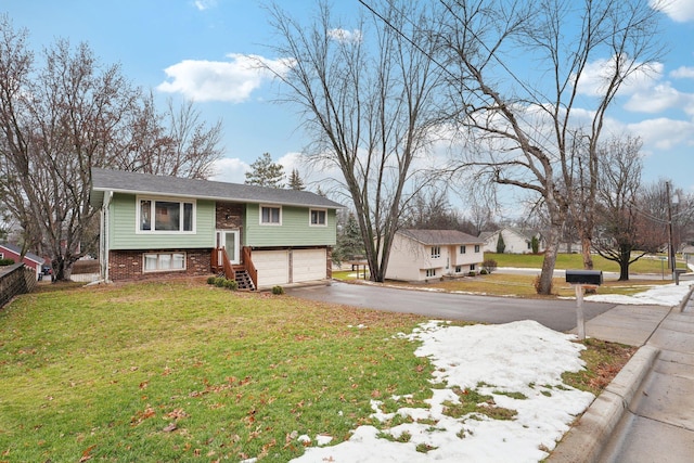 bi-level home with a front yard and a garage