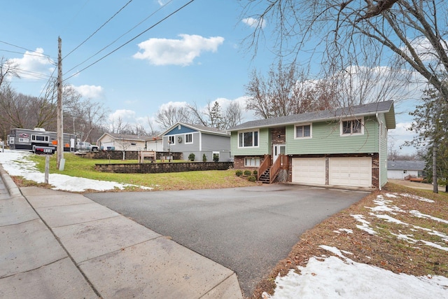 split foyer home with a front lawn and a garage