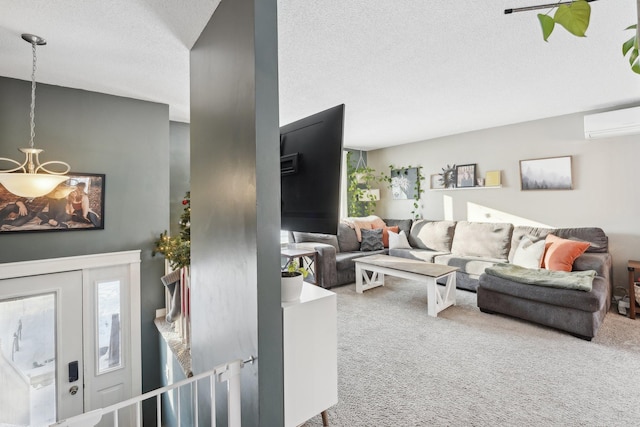 living room featuring carpet floors, a textured ceiling, and a wall mounted AC