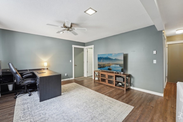 office space with ceiling fan, dark hardwood / wood-style flooring, and a textured ceiling